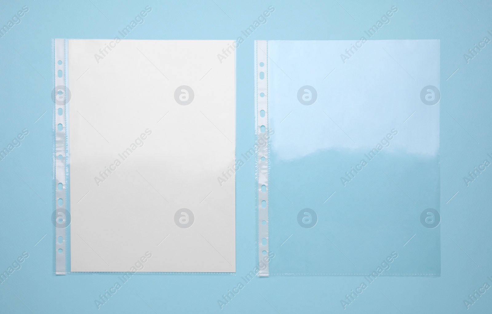 Photo of Punched pockets on turquoise background, flat lay