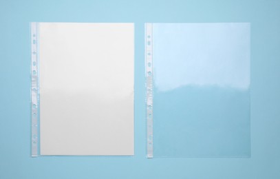 Photo of Punched pockets on turquoise background, flat lay