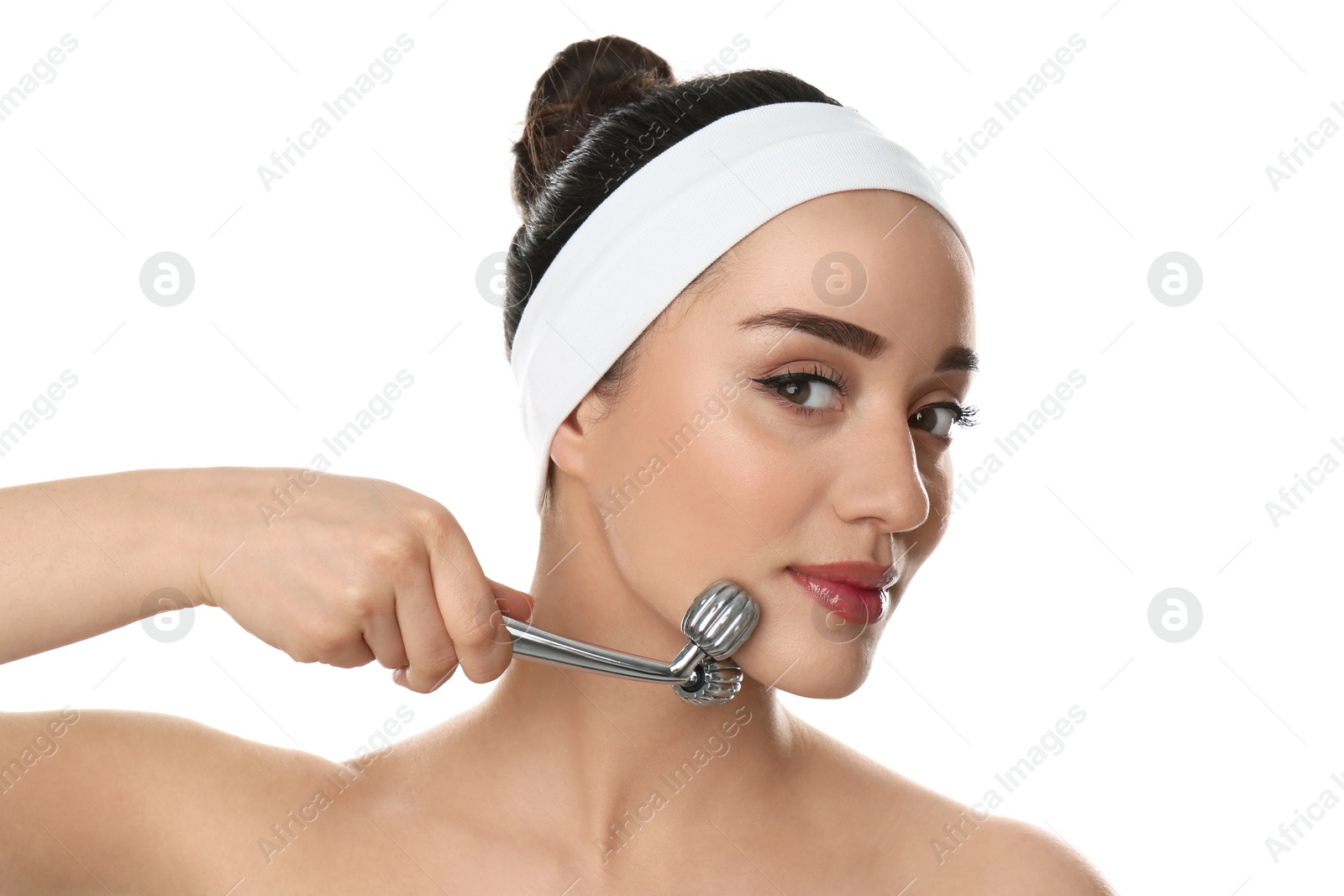 Photo of Woman using metal face roller on white background