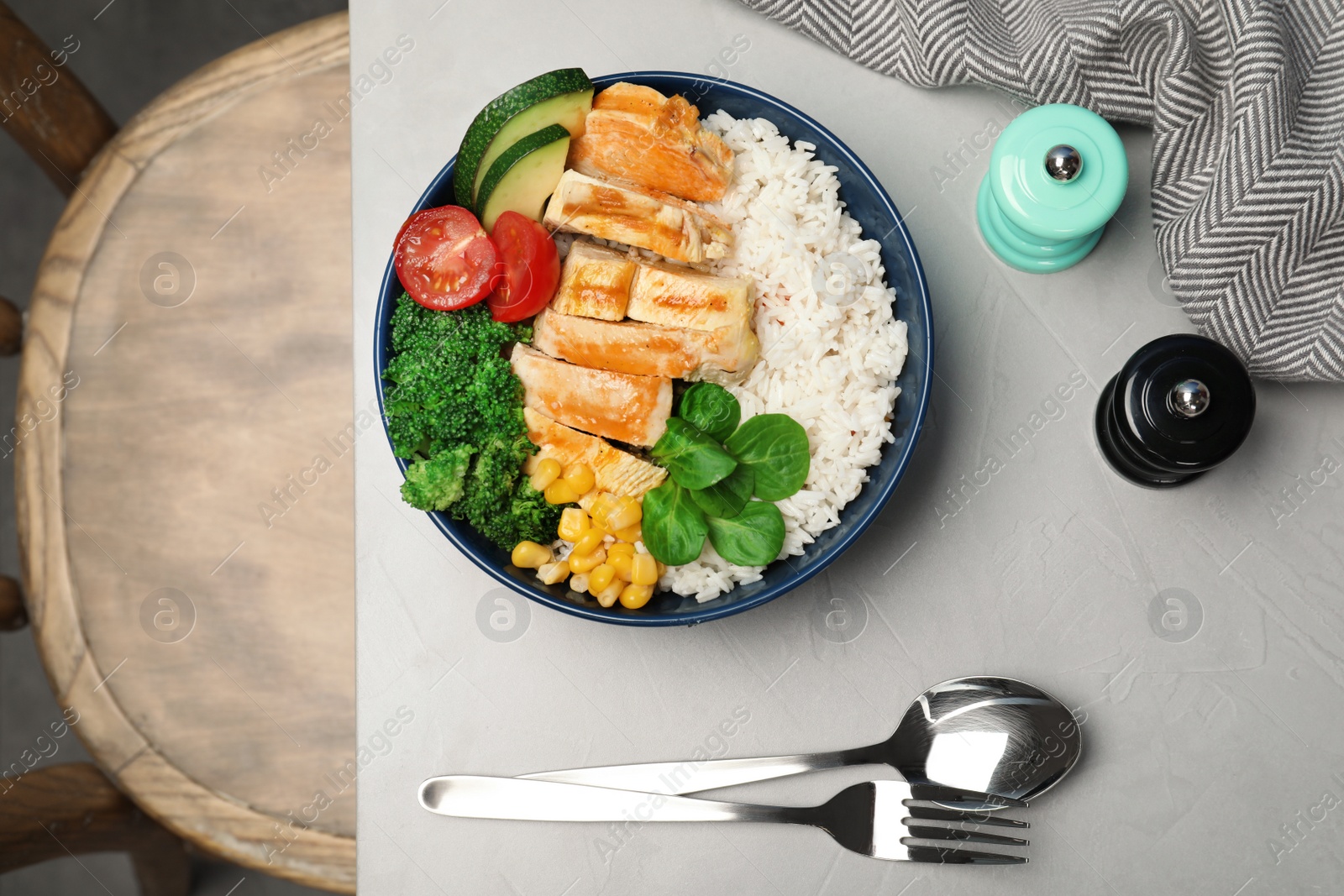 Photo of Boiled rice with vegetables and meat served on table, flat lay