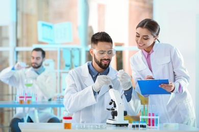 Young scientists working in laboratory. Chemical analysis