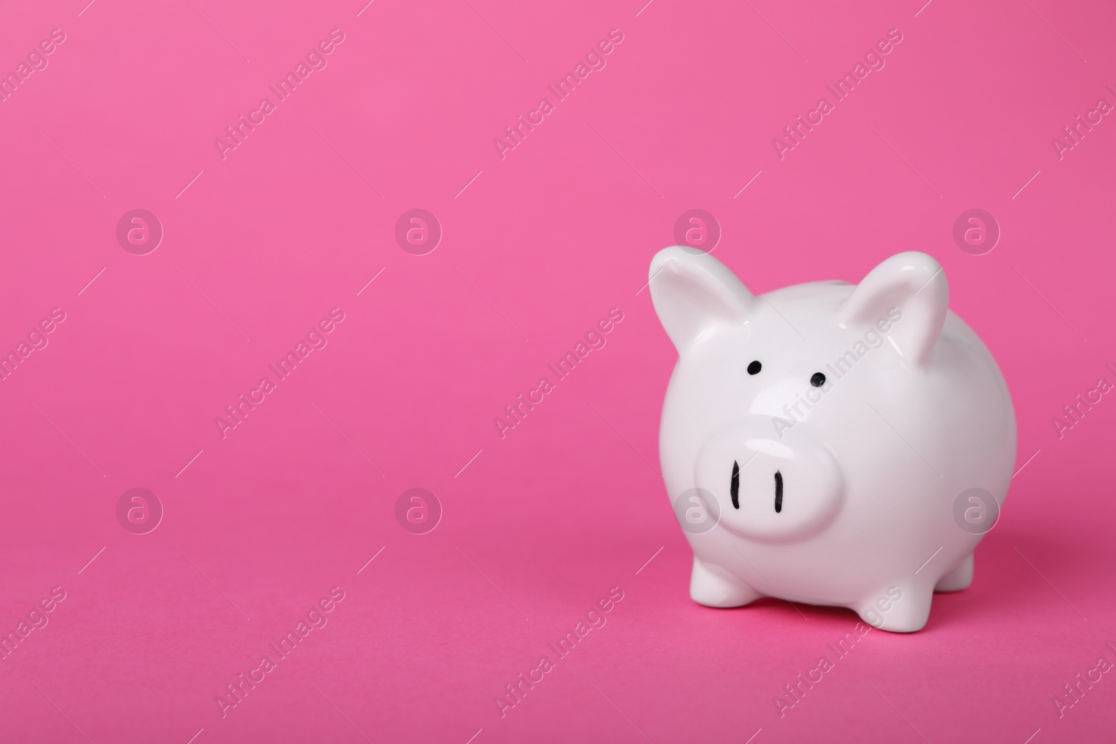 Photo of Ceramic piggy bank on pink background, space for text. Financial savings