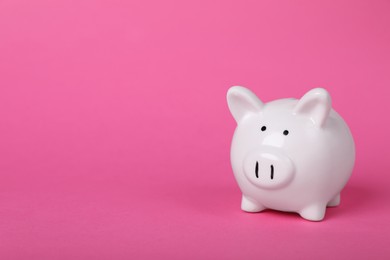 Photo of Ceramic piggy bank on pink background, space for text. Financial savings