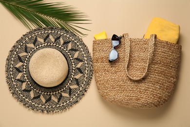 Photo of Flat lay composition with straw hat on beige background