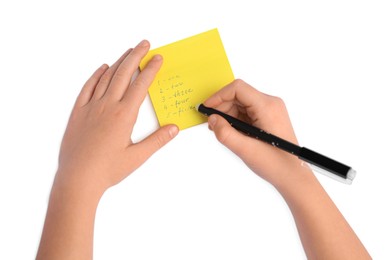 Photo of Child erasing word Five written with erasable pen on sticky note against white background, top view