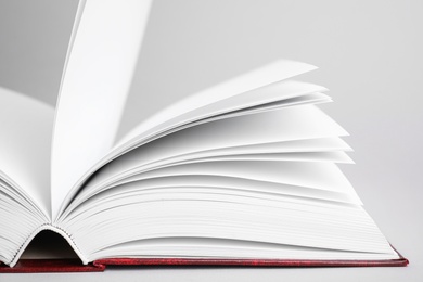 Photo of Closeup view of open book on light background