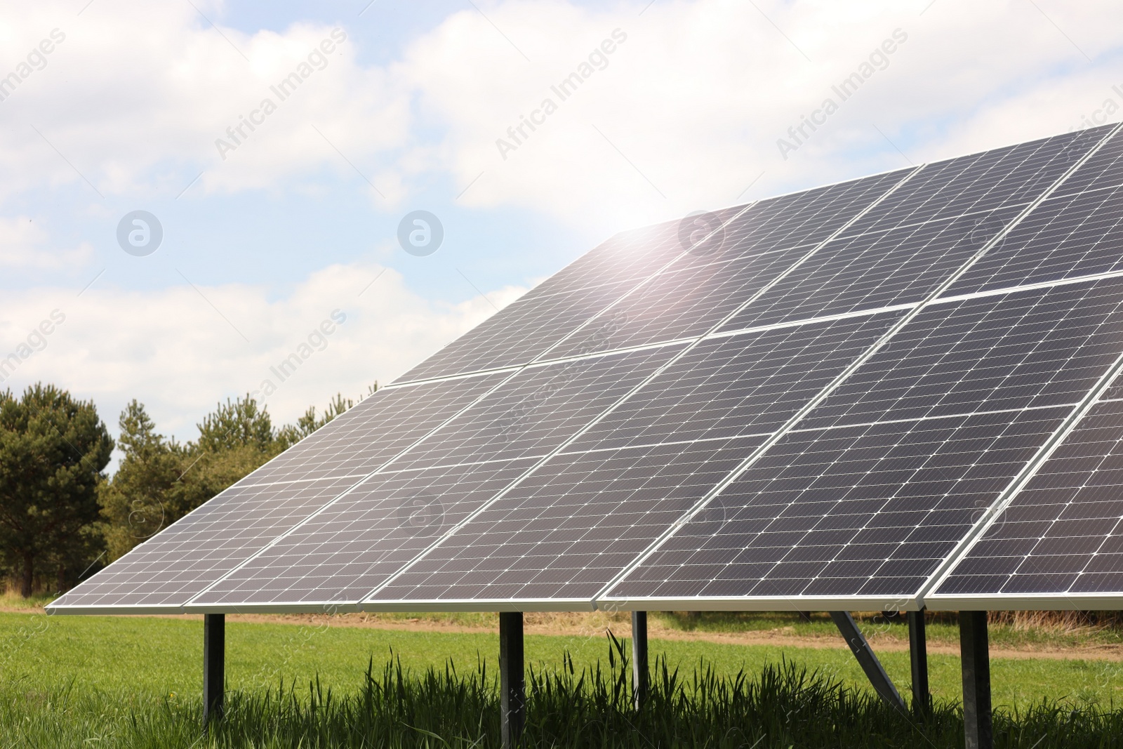 Photo of Solar panels in field on sunny day. Alternative energy