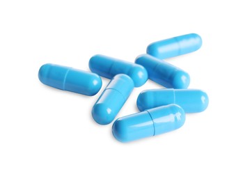 Many light blue pills isolated on white