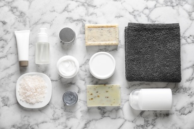 Photo of Flat lay composition with spa cosmetics and towel on light background