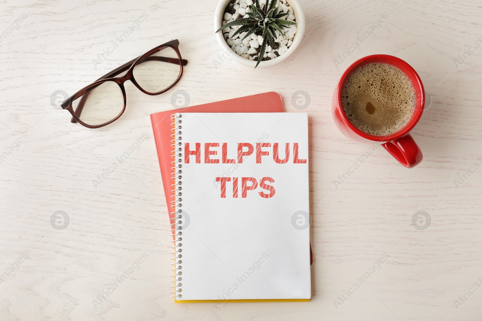 Image of Notebook with text Helpful Tips on wooden table, flat lay