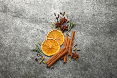 Photo of Different mulled wine ingredients on grey table, flat lay