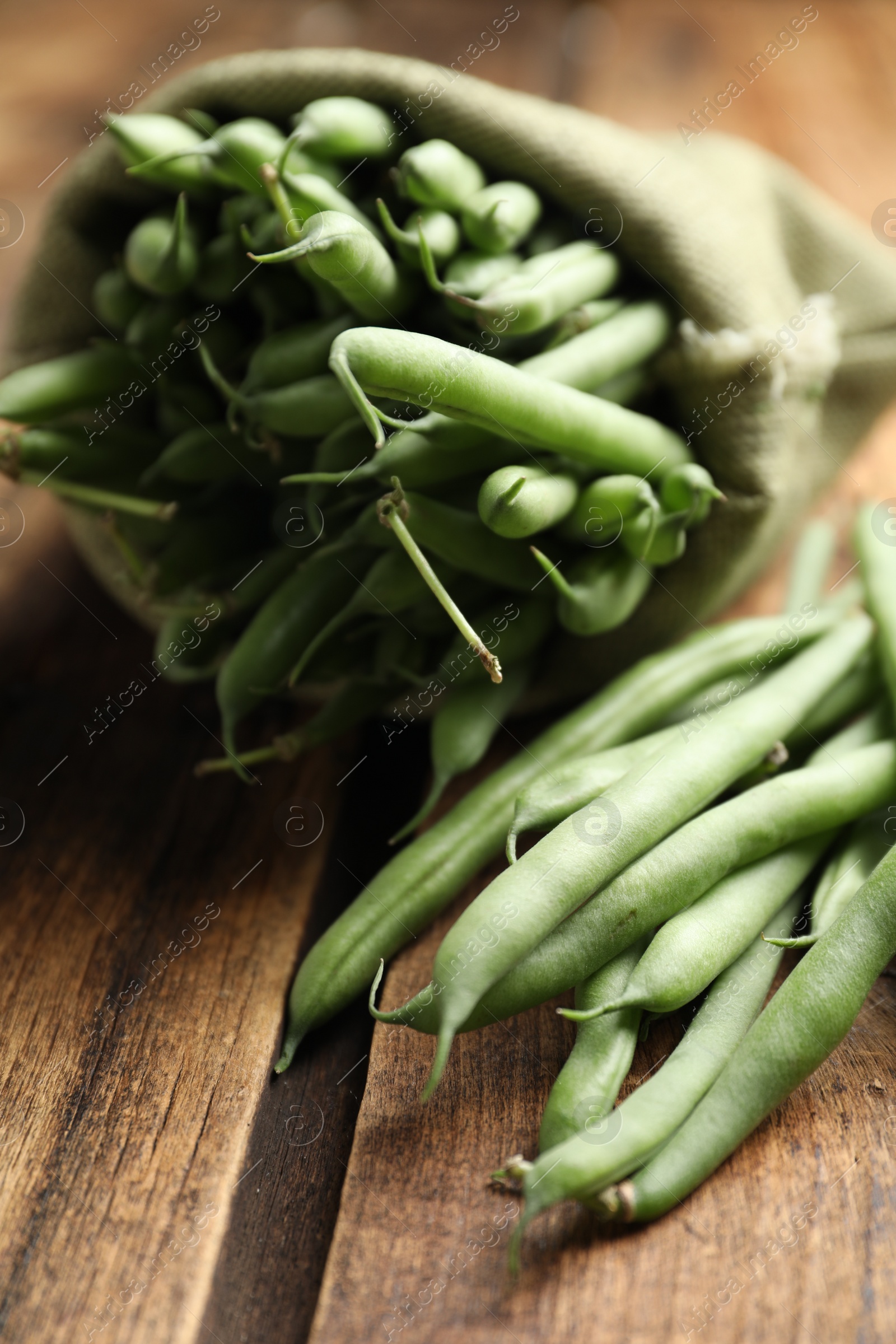 Photo of Delicious fresh green beans on wooden table