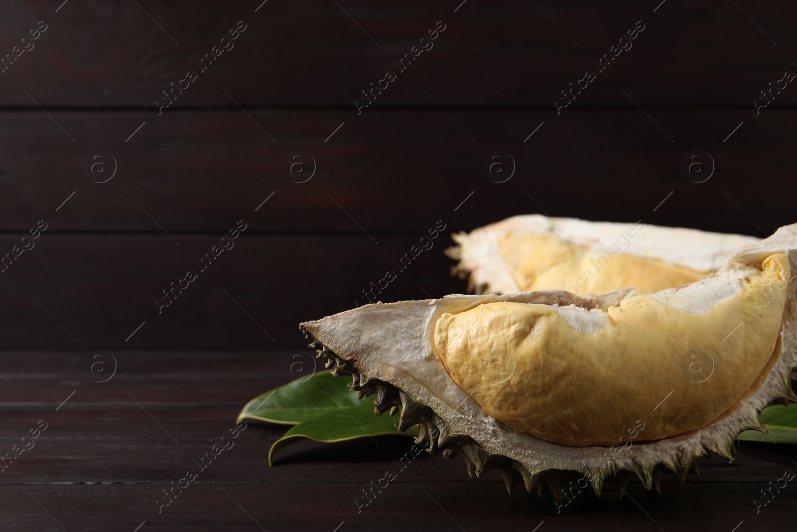 Photo of Fresh ripe durian on wooden table. Space for text