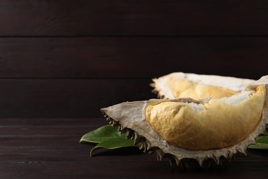 Photo of Fresh ripe durian on wooden table. Space for text