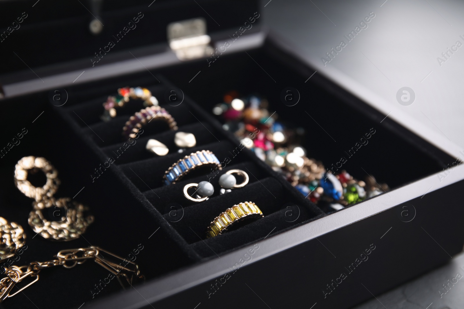 Photo of Jewelry box with stylish bijouterie on table, closeup