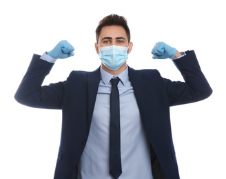 Photo of Businessman with protective mask and gloves showing muscles on white background. Strong immunity concept