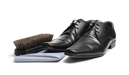 Stylish men's footwear and shoe care accessories on white background