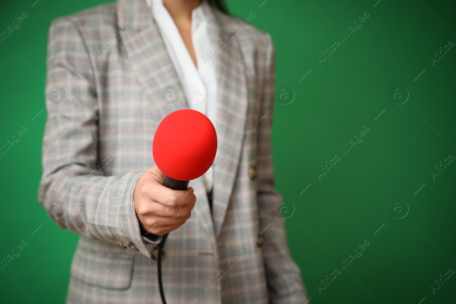 Photo of Journalist with microphone on green background, closeup. Space for text