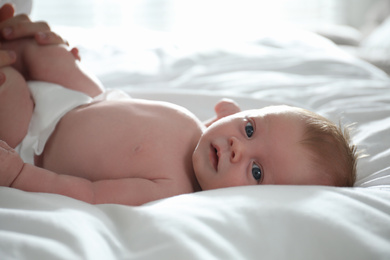 Photo of Cute little newborn baby on bed, closeup