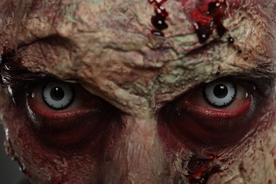 Photo of Closeup view of scary zombie. Halloween monster