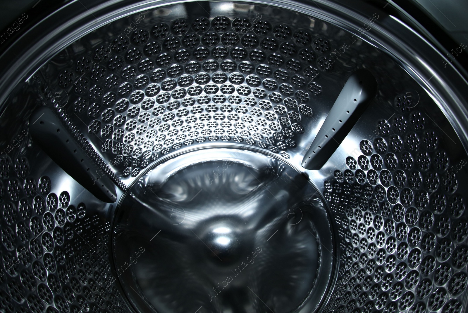 Photo of Empty washing machine drum, closeup view. Laundry day