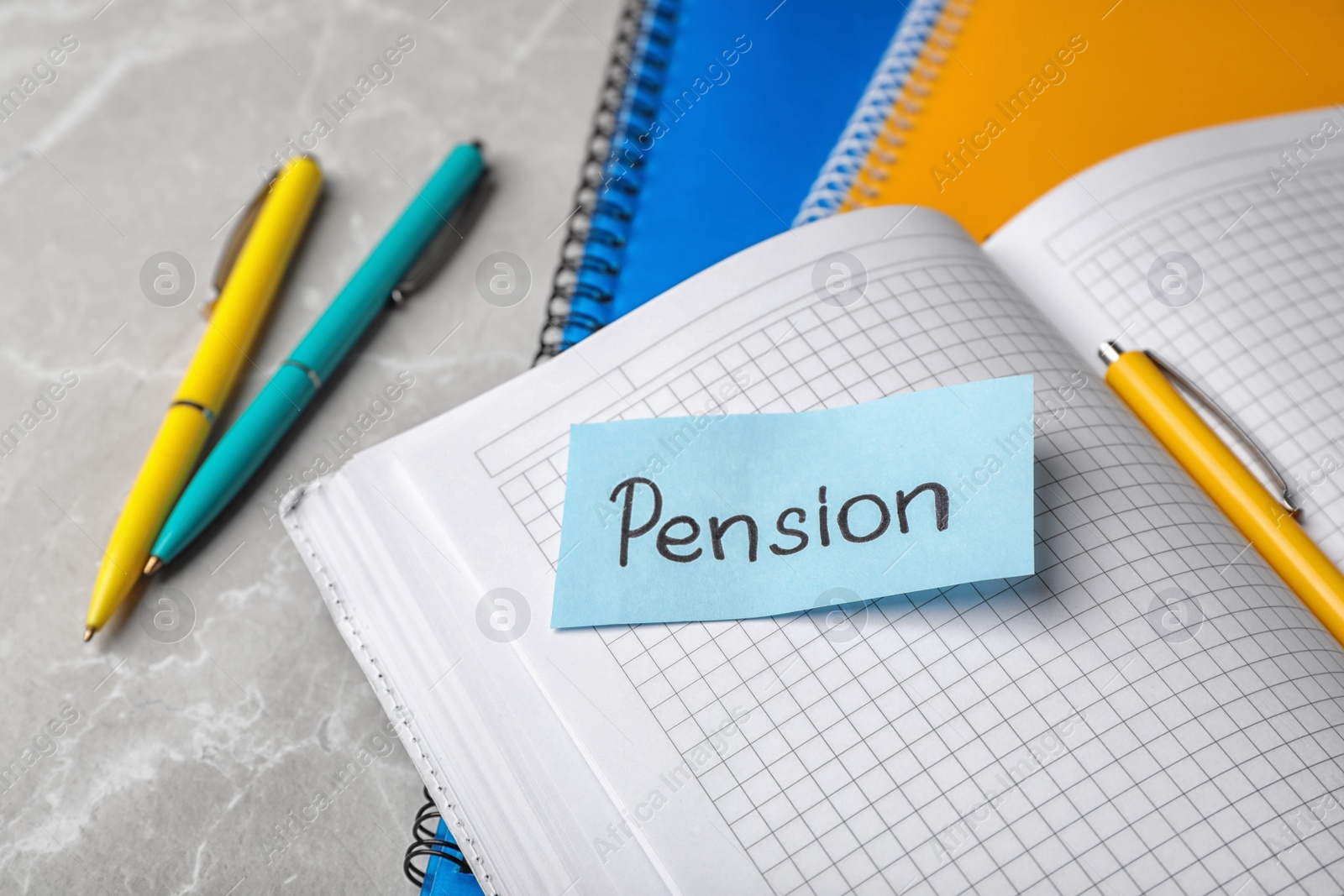 Photo of Paper with word PENSION on page of open notebook