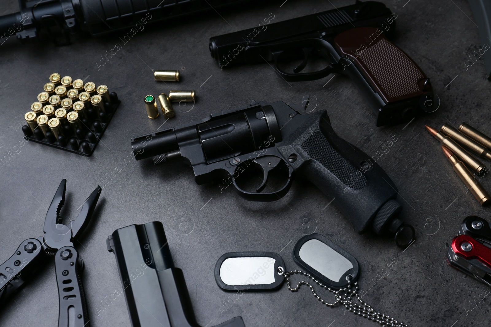 Photo of Composition with professional guns on black background, above view