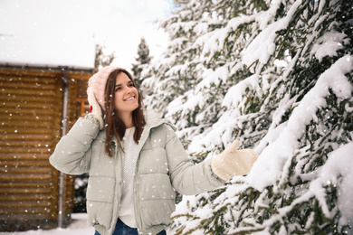 Beautiful young woman outdoors on snowy day. Winter vacation