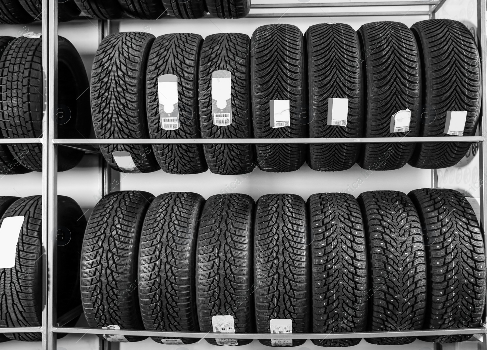 Photo of Car tires on racks in automobile service center