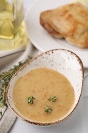 Delicious turkey gravy and thyme on table, closeup