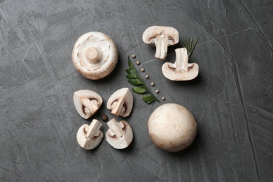 Photo of Flat lay composition with fresh champignon mushrooms on grey background