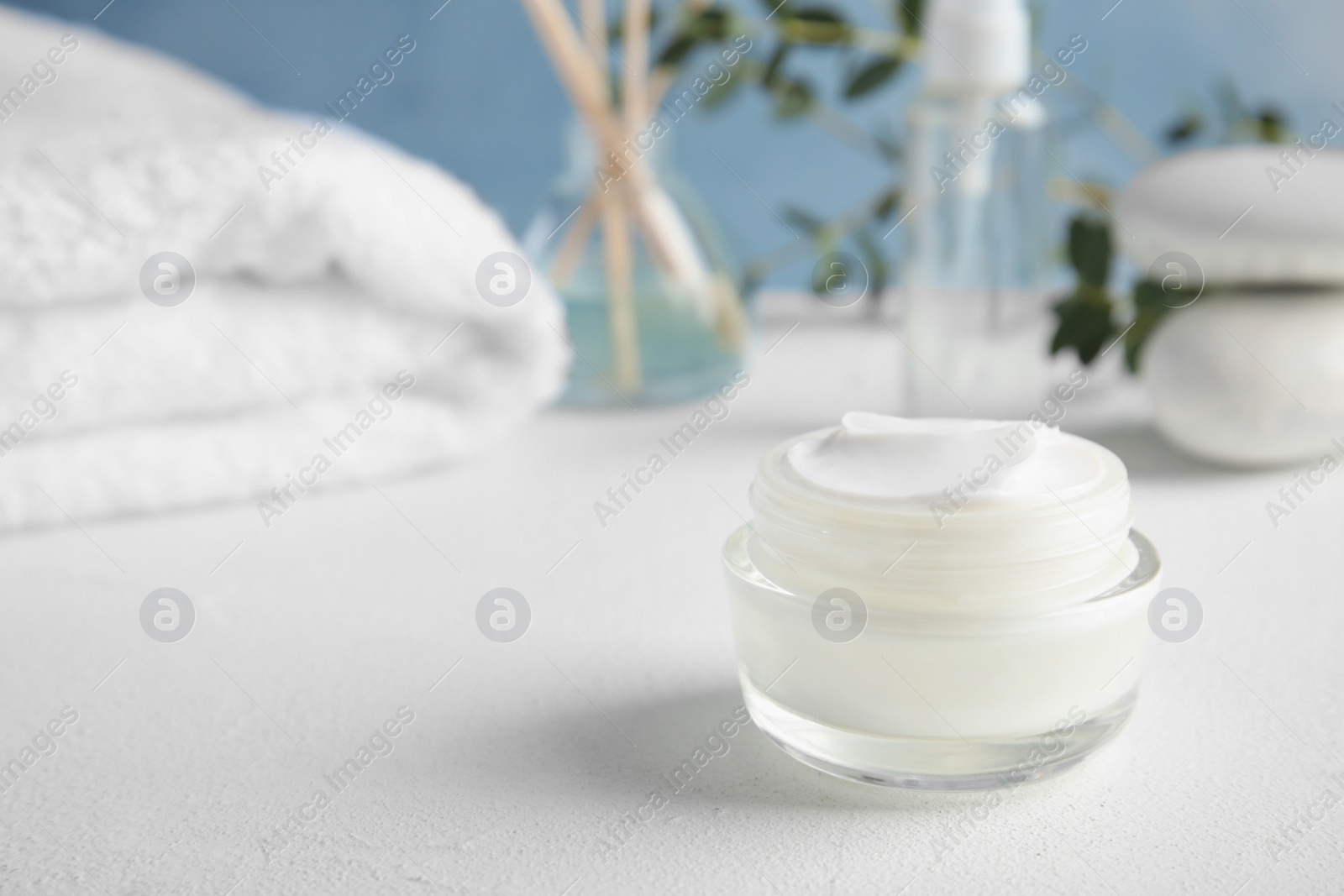 Photo of Jar of body care product on table. Space for text