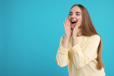 Special promotion. Young woman shouting to announce information on light blue background, space for text
