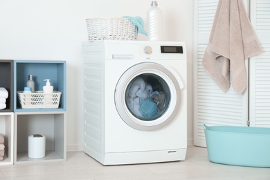 Photo of Washing of different towels in modern laundry room