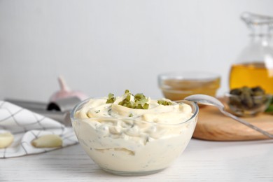 Tasty tartar sauce on white wooden table