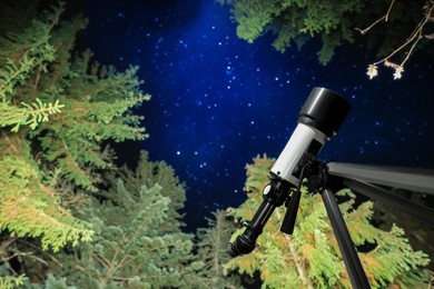 Photo of Modern telescope at night outdoors, low angle view. Learning astronomy