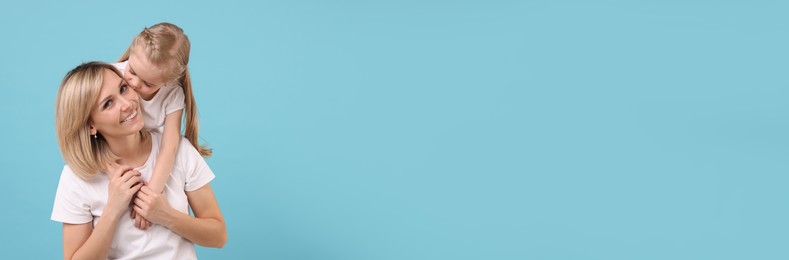 Image of Happy mother and daughter on light blue background, space for text. Banner design