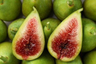 Cut and whole fresh green figs as background, top view