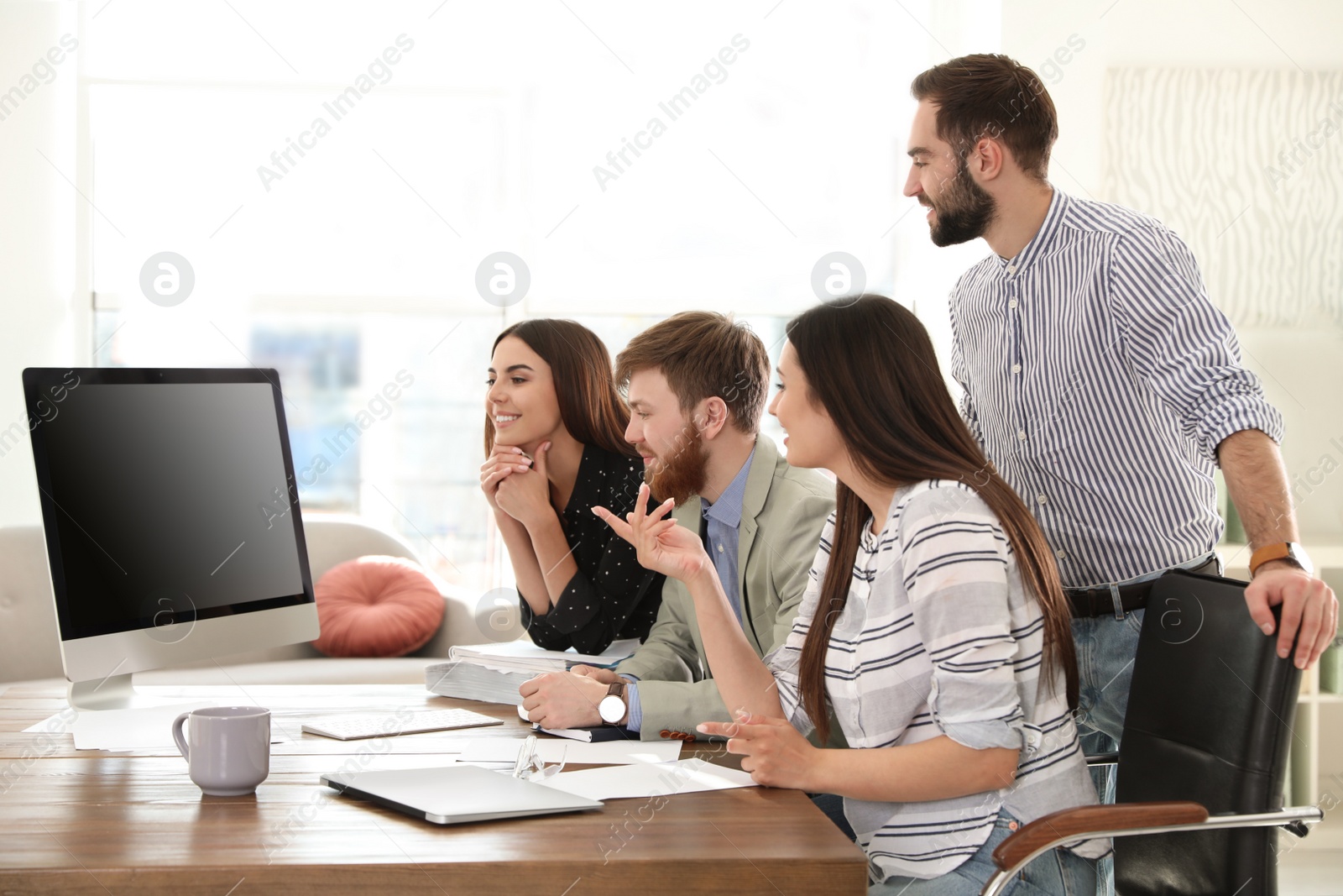 Photo of Group of colleagues using video chat on computer in office. Space for text