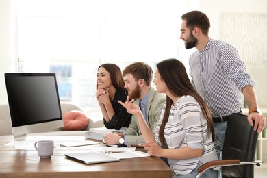 Photo of Group of colleagues using video chat on computer in office. Space for text