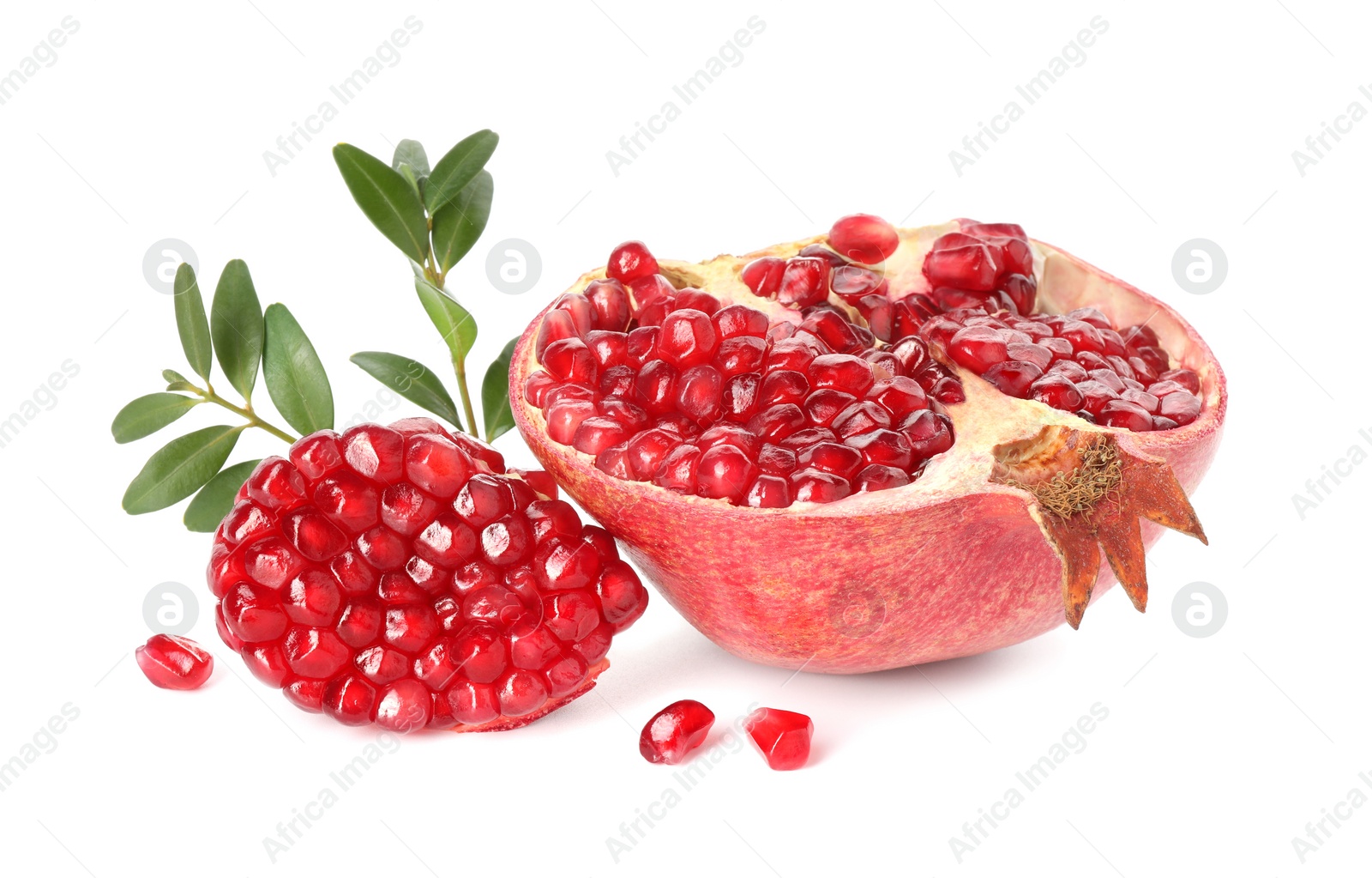 Photo of Fresh cut pomegranate and branches isolated on white