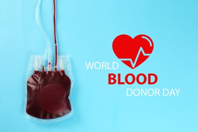 Image of World Donor Day. Blood pack on light blue background, top view