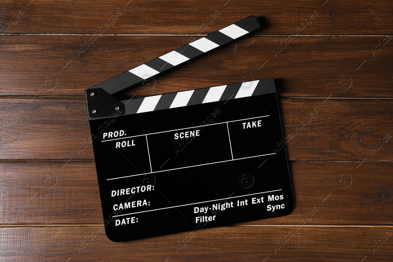 Photo of One clapperboard on wooden table, top view