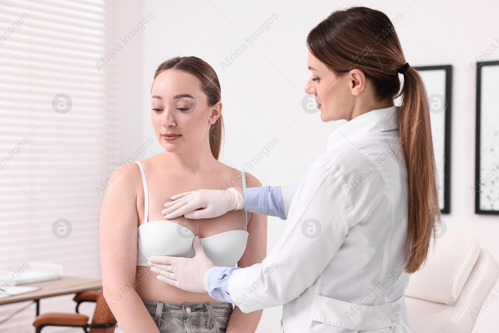 Photo of Mammologist checking young woman's breast in hospital