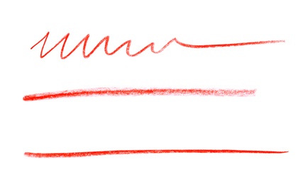 Photo of Red pencil scribbles on white background, top view