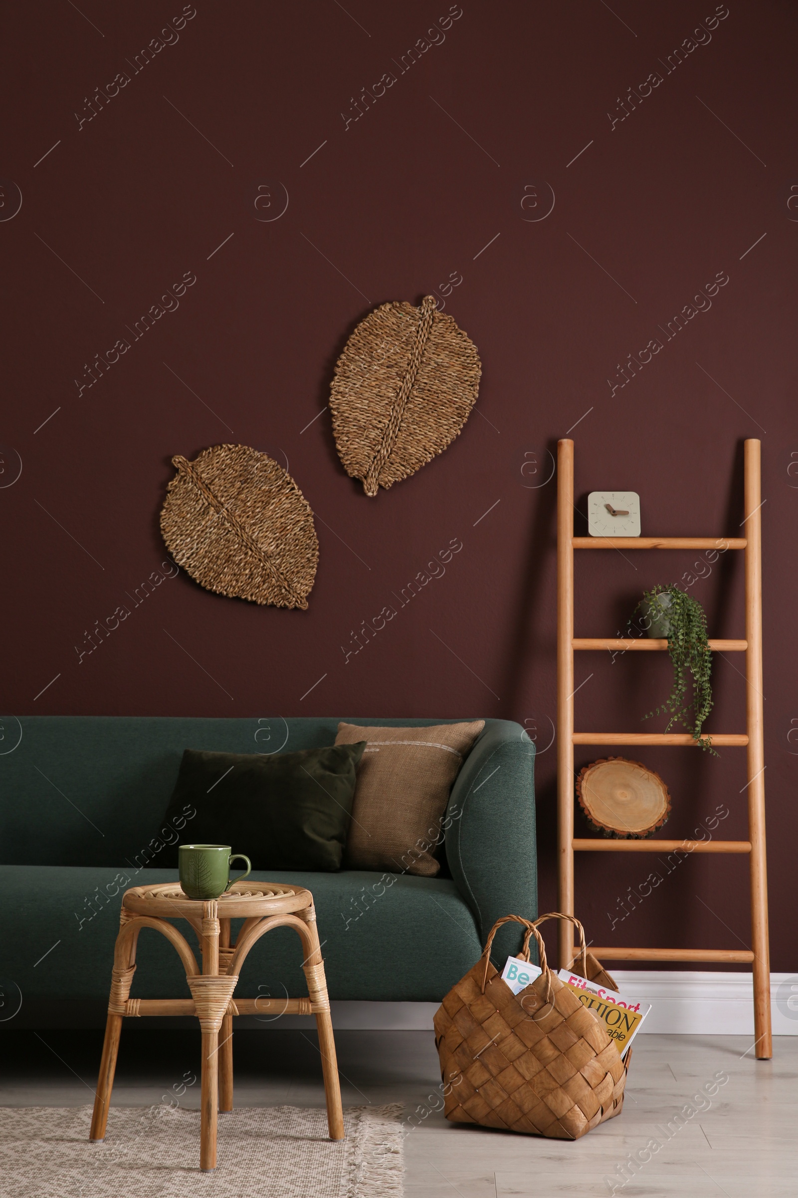 Photo of Comfortable wooden stool near sofa in living room