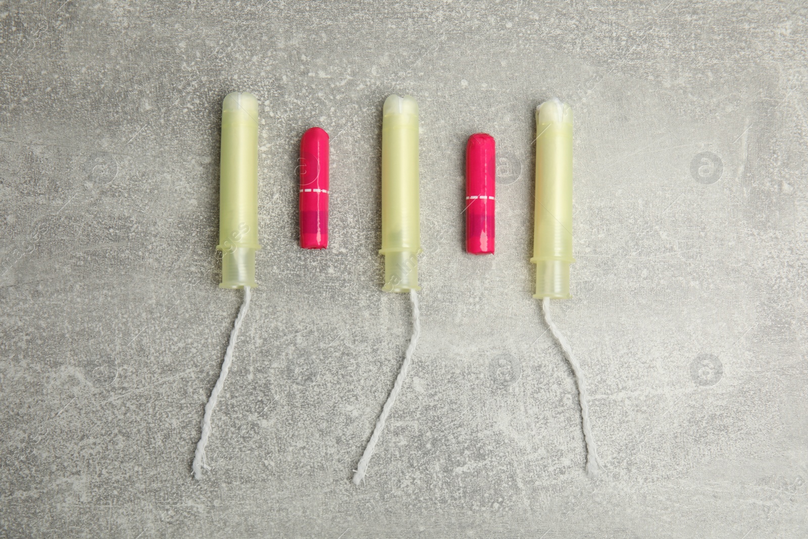 Photo of Tampons on grey background, flat lay. Menstrual hygiene product