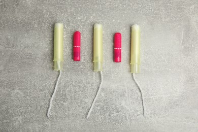 Photo of Tampons on grey background, flat lay. Menstrual hygiene product