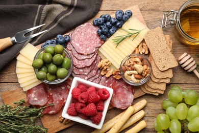 Snack set with delicious Parmesan cheese on wooden table, flat lay