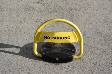 Photo of Parking barrier with No Stopping road sign on asphalt outdoors